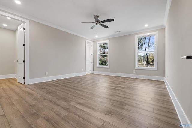 unfurnished room with light hardwood / wood-style floors, plenty of natural light, ornamental molding, and ceiling fan