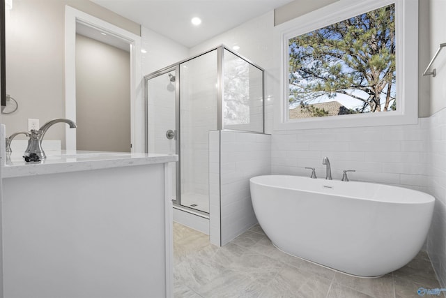 bathroom featuring shower with separate bathtub