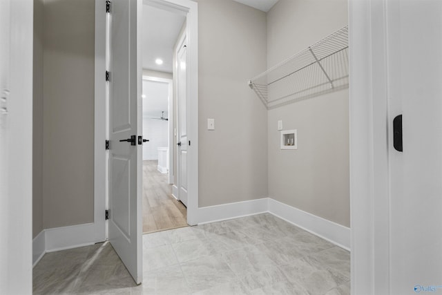 laundry area with washer hookup and light tile patterned floors