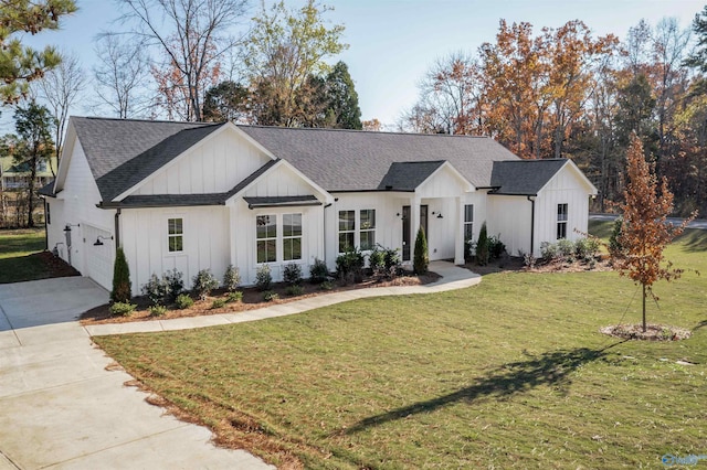 modern inspired farmhouse featuring a front yard and a garage