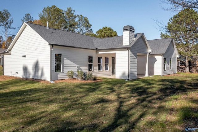 rear view of house with a yard