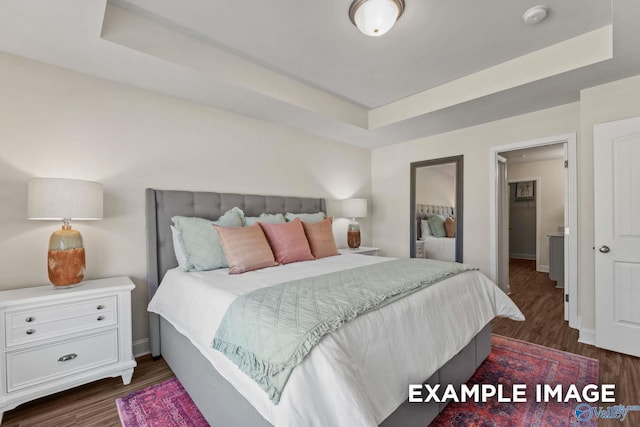 152 Rose Valley Dr, New Market, AL 35761 - bedroom with a tray ceiling, baseboards, and dark wood-style flooring