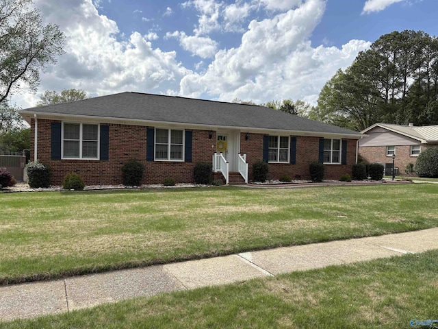 ranch-style house featuring a front lawn and brick siding