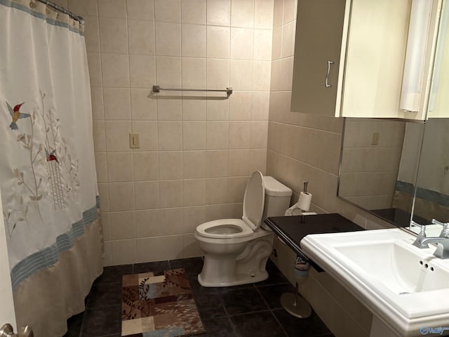 full bath featuring tile patterned floors, a sink, toilet, and tile walls