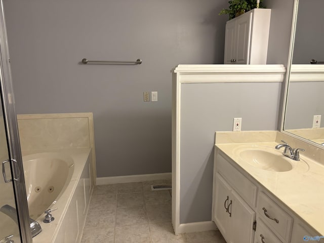 full bathroom featuring baseboards, tile patterned floors, vanity, and a jetted tub
