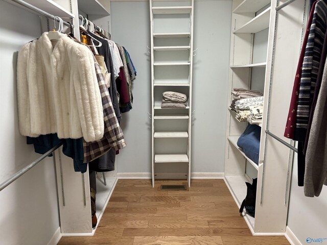 spacious closet featuring wood finished floors