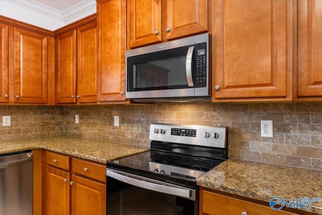 kitchen featuring ornamental molding, light stone countertops, stainless steel appliances, and tasteful backsplash