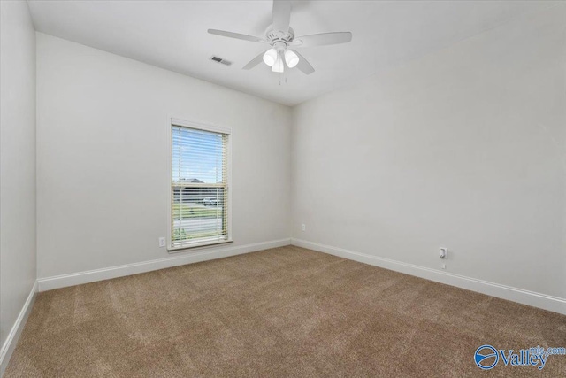 spare room featuring carpet flooring and ceiling fan