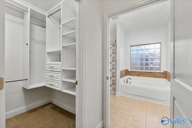 walk in closet featuring light tile patterned flooring