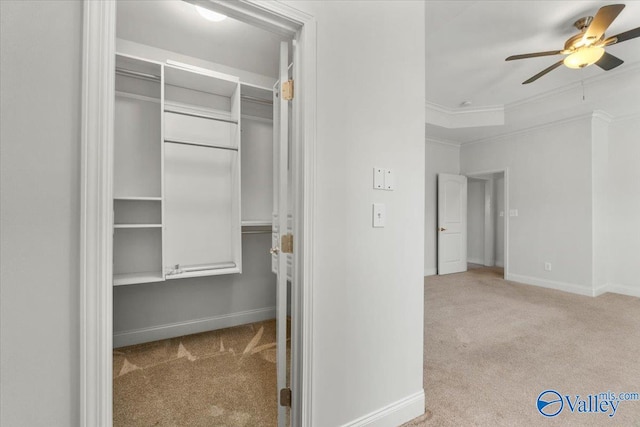 walk in closet with light carpet and ceiling fan