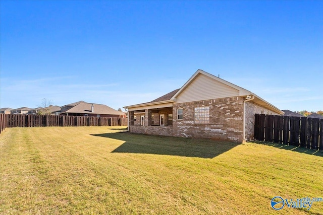 rear view of house with a yard