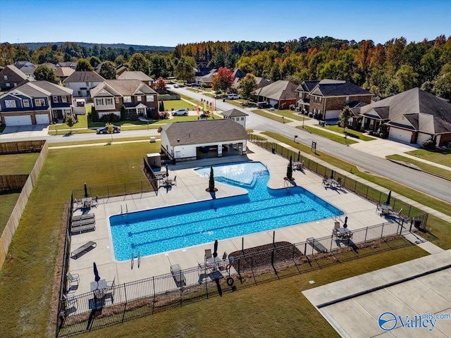 view of swimming pool featuring a patio area and a lawn