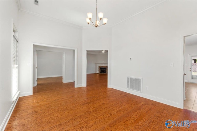 interior space with light hardwood / wood-style floors, crown molding, and a wealth of natural light