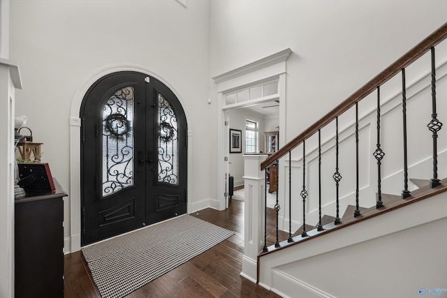 foyer with dark hardwood / wood-style flooring, french doors, and a high ceiling