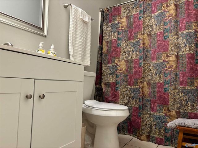 bathroom featuring toilet, tile patterned floors, and curtained shower