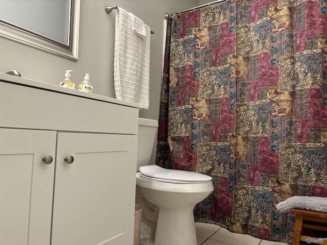 bathroom featuring toilet, tile patterned floors, vanity, and curtained shower