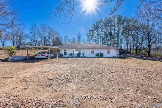 ranch-style home featuring a carport