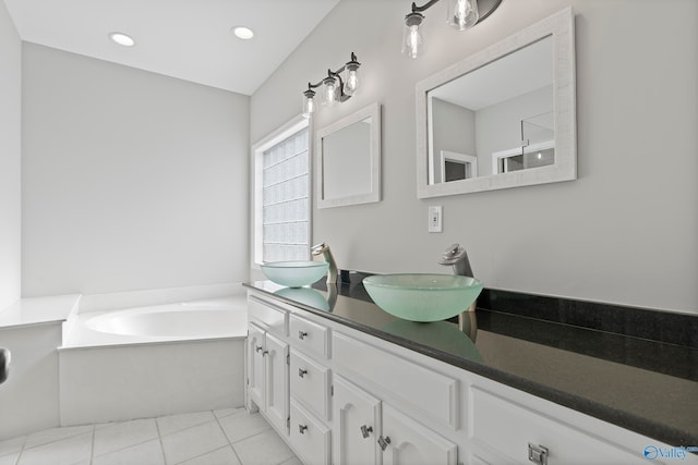 bathroom featuring vanity, tile patterned floors, and a bathtub