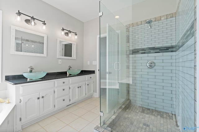 bathroom with tile patterned flooring, vanity, and a shower with shower door