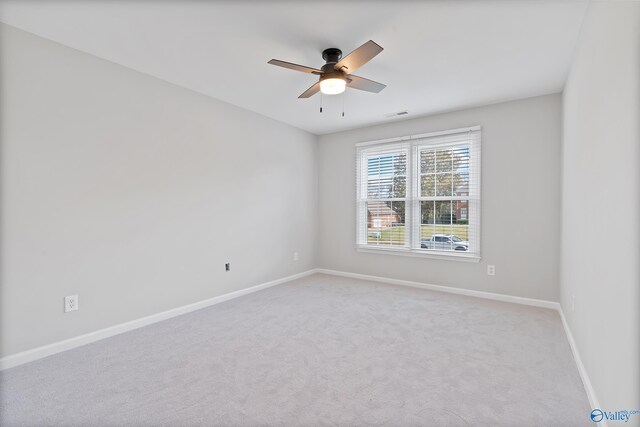 carpeted empty room featuring ceiling fan