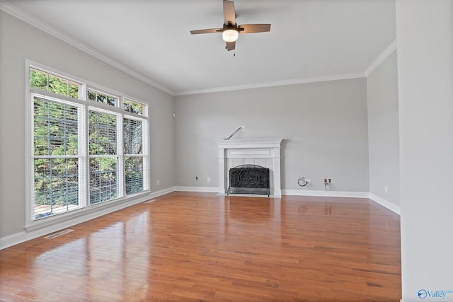 unfurnished living room featuring hardwood / wood-style floors, ceiling fan, and crown molding