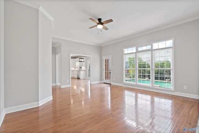 empty room with ceiling fan, light hardwood / wood-style flooring, and ornamental molding