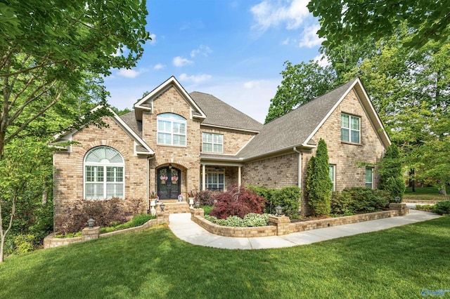39 Verdant Cir, Huntsville, AL 35803 - traditional-style house featuring brick siding, a front yard, and a shingled roof