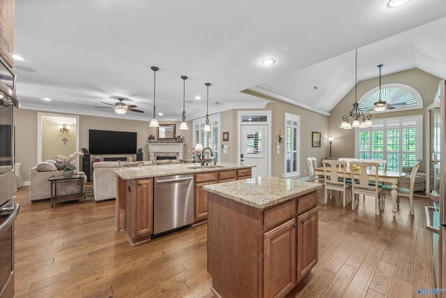 39 Verdant Cir, Huntsville, AL 35803 - kitchen with appliances with stainless steel finishes, a kitchen island with sink, ceiling fan, a fireplace, and open floor plan