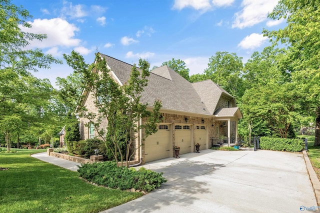 39 Verdant Cir, Huntsville, AL 35803 - view of home's exterior featuring an attached garage, a yard, driveway, and a shingled roof