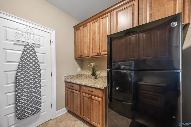 39 Verdant Cir, Huntsville, AL 35803 - kitchen featuring freestanding refrigerator, light stone countertops, and brown cabinetry