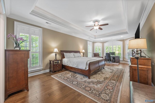 39 Verdant Cir, Huntsville, AL 35803 - bedroom featuring a raised ceiling, hardwood / wood-style flooring, a desk, ornamental molding, and recessed lighting