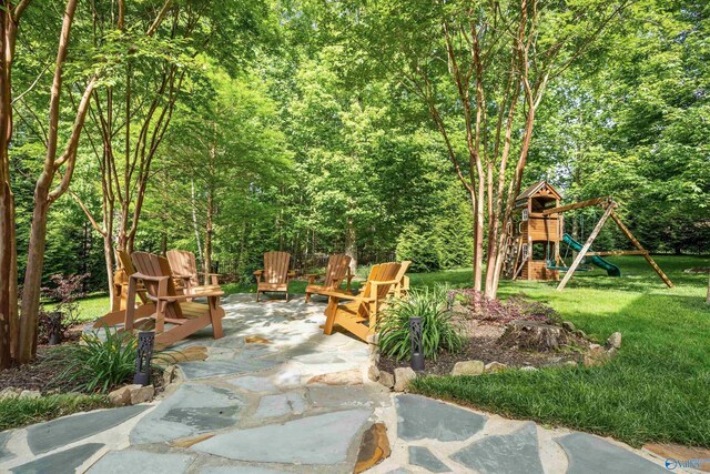 39 Verdant Cir, Huntsville, AL 35803 - view of patio featuring a playground and a forest view