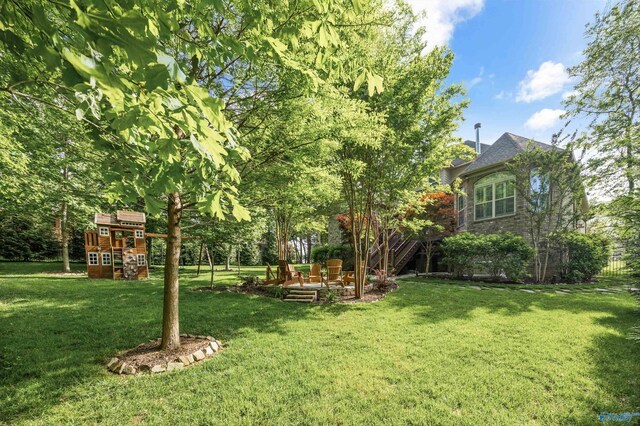 39 Verdant Cir, Huntsville, AL 35803 - view of grassy yard with a playground and a patio area