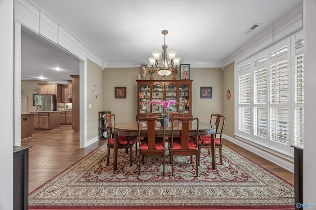 39 Verdant Cir, Huntsville, AL 35803 - dining room with a chandelier, wood finished floors, and crown molding
