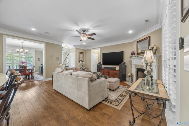 39 Verdant Cir, Huntsville, AL 35803 - living area with stairs, a chandelier, wood finished floors, ceiling fan, and a fireplace with flush hearth