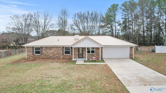 ranch-style house featuring a garage and a front lawn