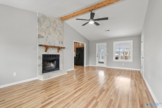 unfurnished living room with high vaulted ceiling, ceiling fan, light wood-type flooring, a fireplace, and beam ceiling