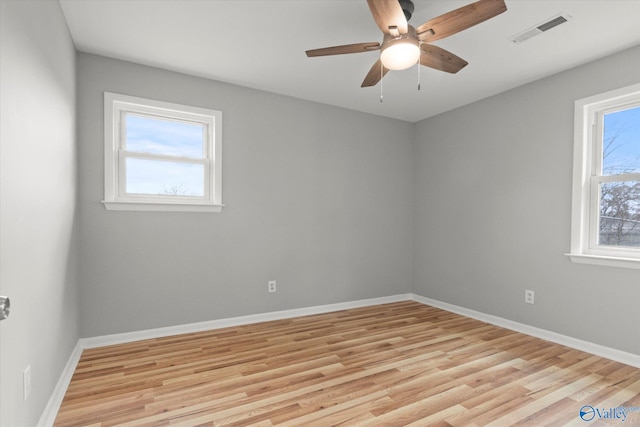 spare room featuring light hardwood / wood-style flooring and ceiling fan