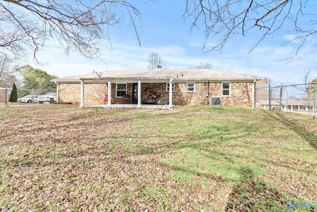 rear view of house with a lawn and a patio