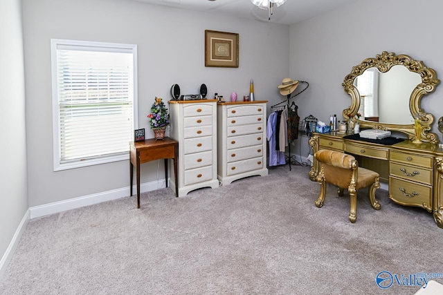 home office featuring light carpet and ceiling fan