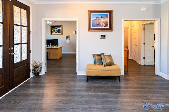 foyer entrance with french doors, ornamental molding, and dark wood-type flooring