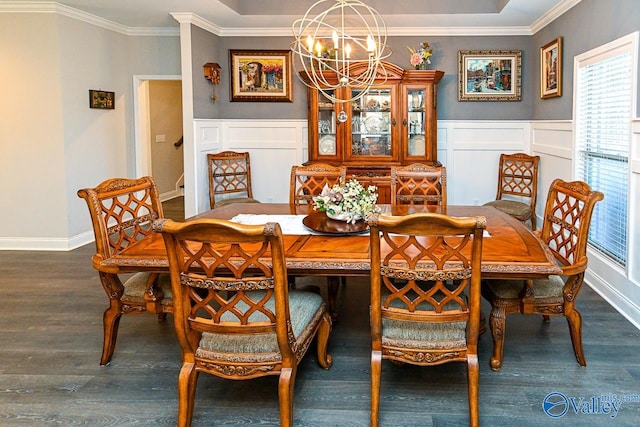 dining area featuring ornamental molding, dark hardwood / wood-style floors, and an inviting chandelier