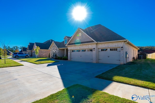 view of front of house featuring a front yard and a garage