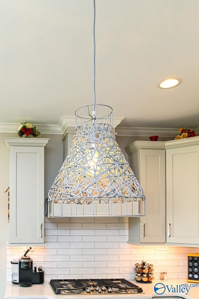 kitchen with crown molding, decorative backsplash, and white cabinets