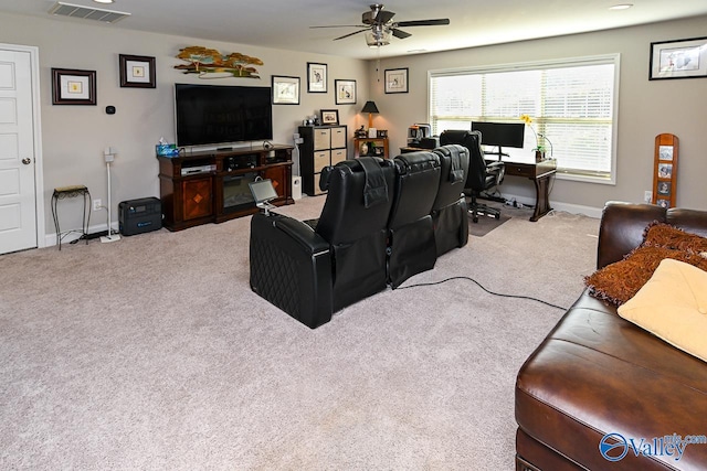 living room with ceiling fan and carpet