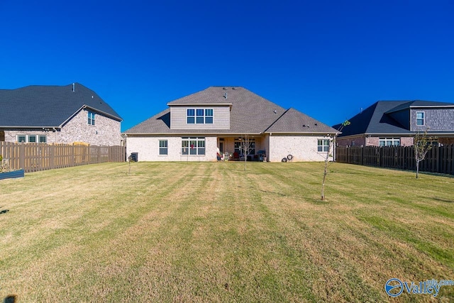 rear view of house with a yard