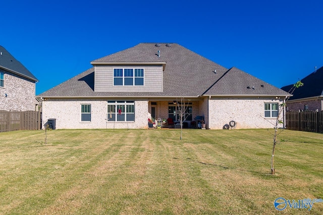 back of property featuring a lawn