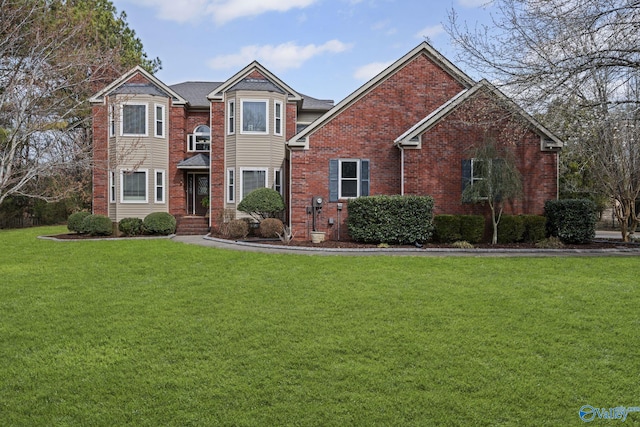 view of front of house with brick siding and a front yard