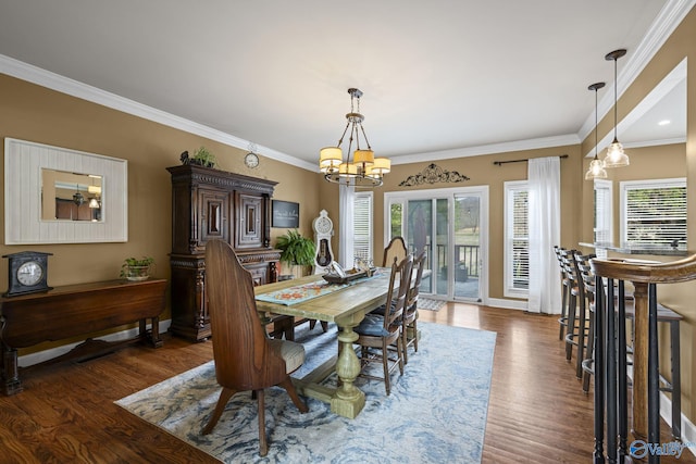 dining room featuring crown molding, dark wood-style floors, baseboards, and a chandelier