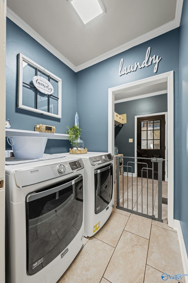 laundry area with crown molding, light tile patterned flooring, independent washer and dryer, and laundry area